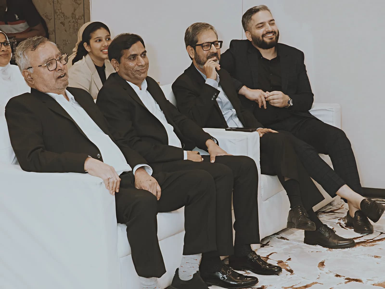 Panel guests seated beside the stage at HiBizz, Goa
