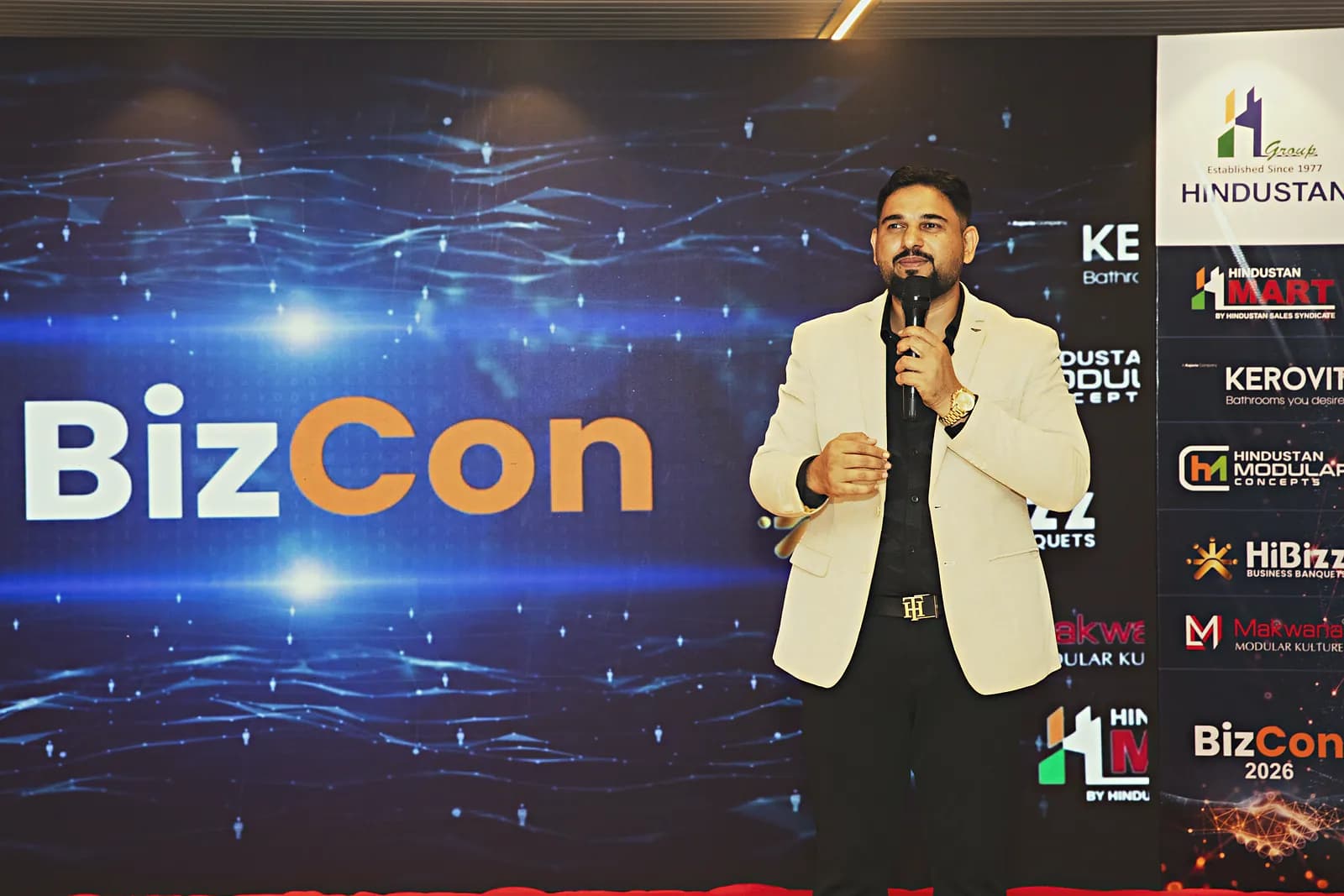 Keynote speaker addressing delegates from the HiBizz stage in Goa