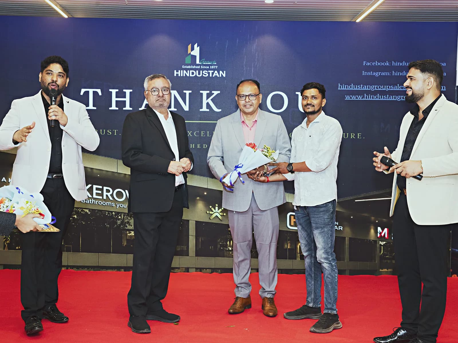Guests being presented with bouquets on the red carpet at HiBizz, Goa