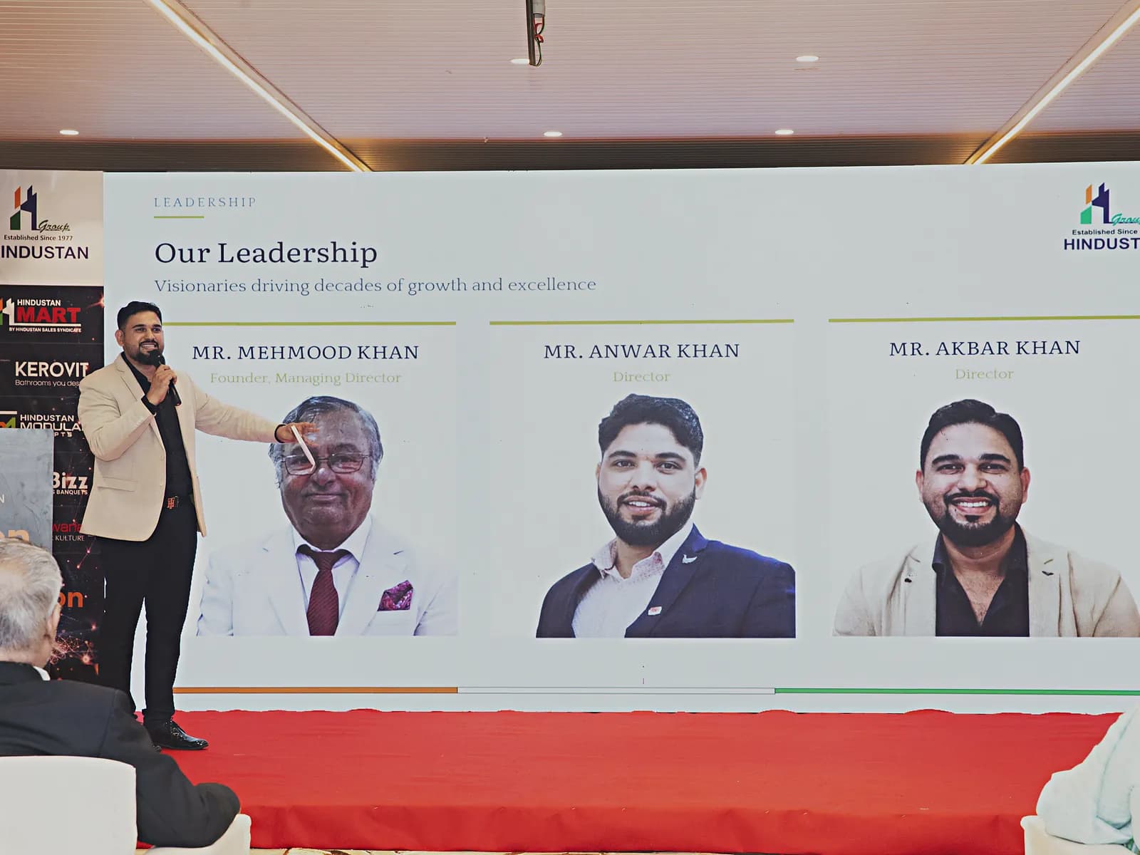 Stage, presentation screen and podium at the front of the HiBizz event hall in Goa