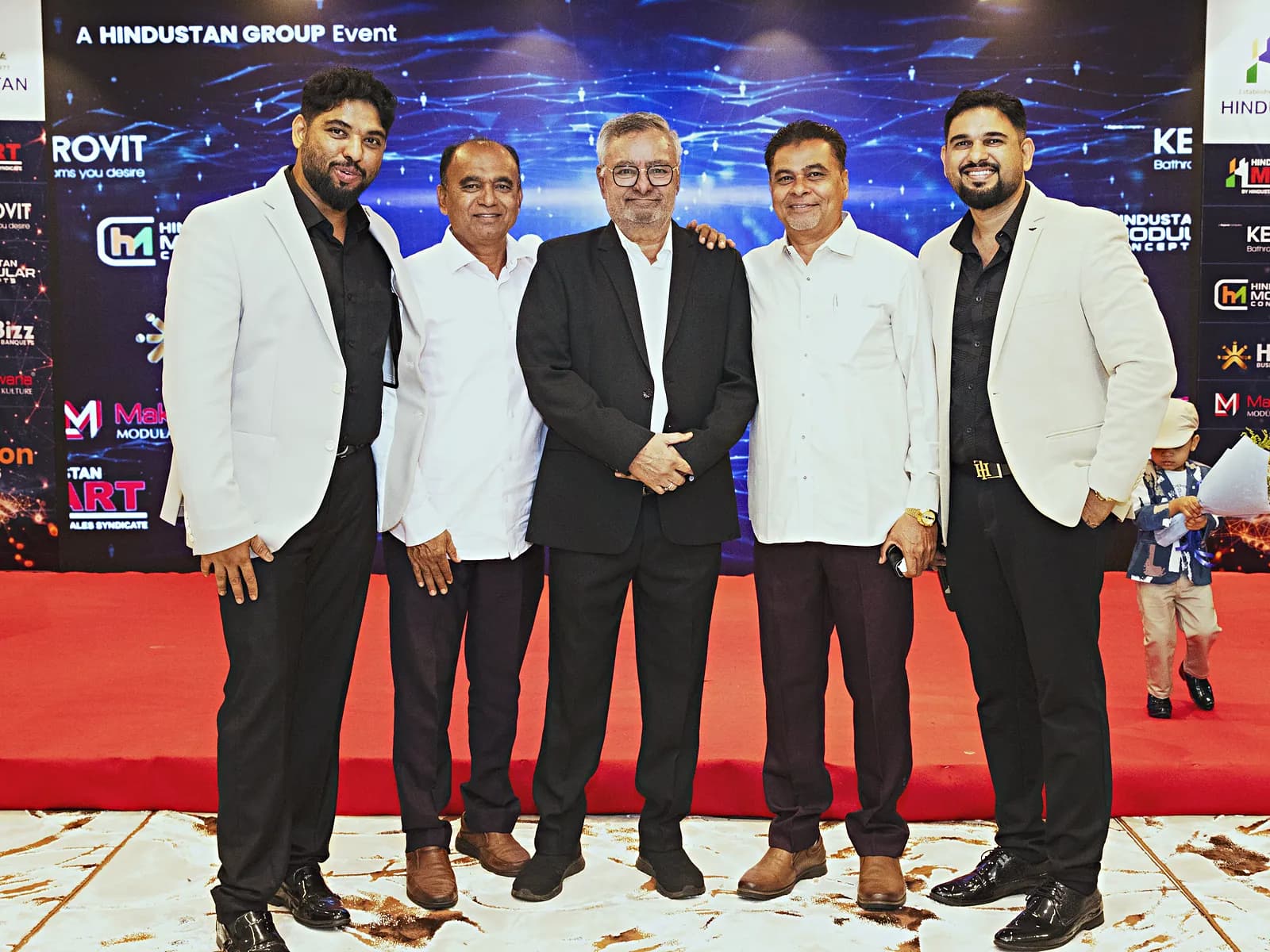 Guests standing on the red carpet stage front at a HiBizz corporate event in Goa